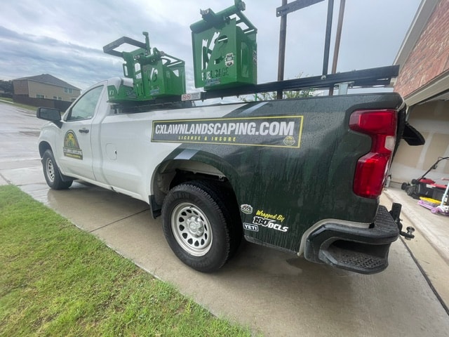 CX Lawn & Landscaping branded service truck with equipment rack